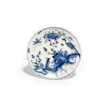 A delftware plate mid 18th century, decorated in a deep blue with an exotic bird perched atop of