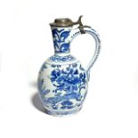 A Delft jug or ewer c.1680-1700, the ovoid body painted in a rich blue with peacocks and other birds