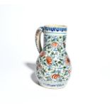 A Delft jug or tankard c.1700-20, painted in red, green and blue with a bird perched on large