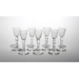 Seven wine glasses c.1770, each rounded funnel bowl engraved with a flower stem including narcissus,