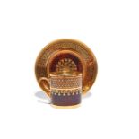 A Sèvres coffee can and saucer dated 1818, decorated with a formal gilt chequered design