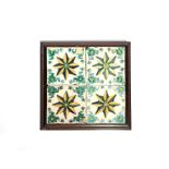 A panel of four Continental faïence tiles 18th/19th century, painted in blue, green, yellow and