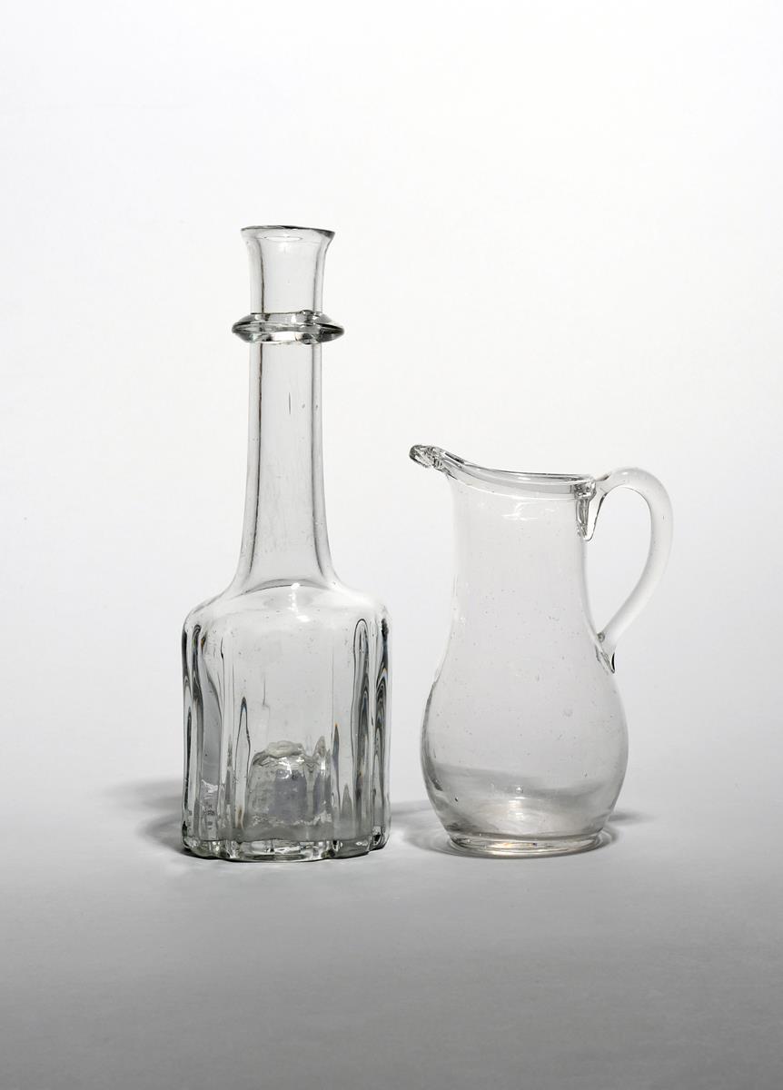 A cruciform decanter or serving bottle c.1740, the heavy base rising to a tall neck with slightly