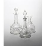 Two small decanters and stoppers and a carafe 19th century, all of globular form rising to a long