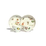 Two Bristol teabowls and a saucer c.1775-80, with shaped rims, painted with flower stems in a