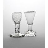 Two firing glasses late 18th century, one with a rounded funnel bowl engraved with flowers above a