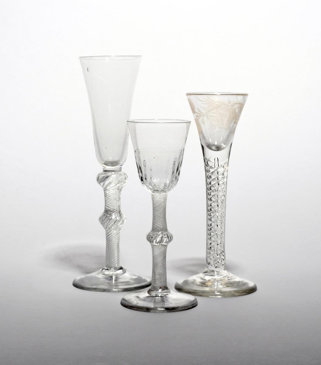 A small wine or cordial glass c.1760, the drawn trumpet bowl engraved with a rose spray above a