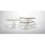 Three glass tazzae mid 18th century, in three sizes, with flat circular tops with galleried rims,