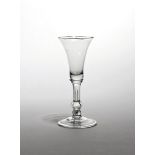 A balustroid wine glass c.1740, the slender bell bowl raised on a stem with inverted baluster knop