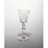 A Dutch-engraved light baluster goblet c.1765, the generous rounded funnel bowl engraved with two
