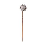A diamond cluster stickpin, set with an old cushion-shaped diamond within a border of single-cut