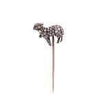 A Victorian diamond-set lamb stickpin, the stylised lamb with a ruby eye is pavé-set with rose-cut