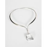 A Georg Jensen silver neck ring and rock crystal pendant designed by Vivianna Torun Bulow-Hube,