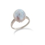 A natural pearl ring, the silver pearl set with diamonds to the shoulders in platinum, size P 1/2