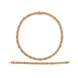 A fluted gold collar necklace, the links separated with three round brilliant-cut diamonds (total