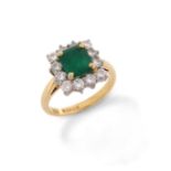 An emerald and diamond cluster ring, the emerald-cut emerald set within a surround of round