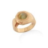A chrysoberyl catseye and gold ring, the cabochon chrysoberyl set in textured yellow gold mount,