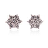 A pair of diamond cluster ear studs, the round brilliant-cut diamonds weigh approximately 0.65cts in