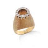 A diamond-set gold ring, the high domed textured gold ring surmounted with a circle of round