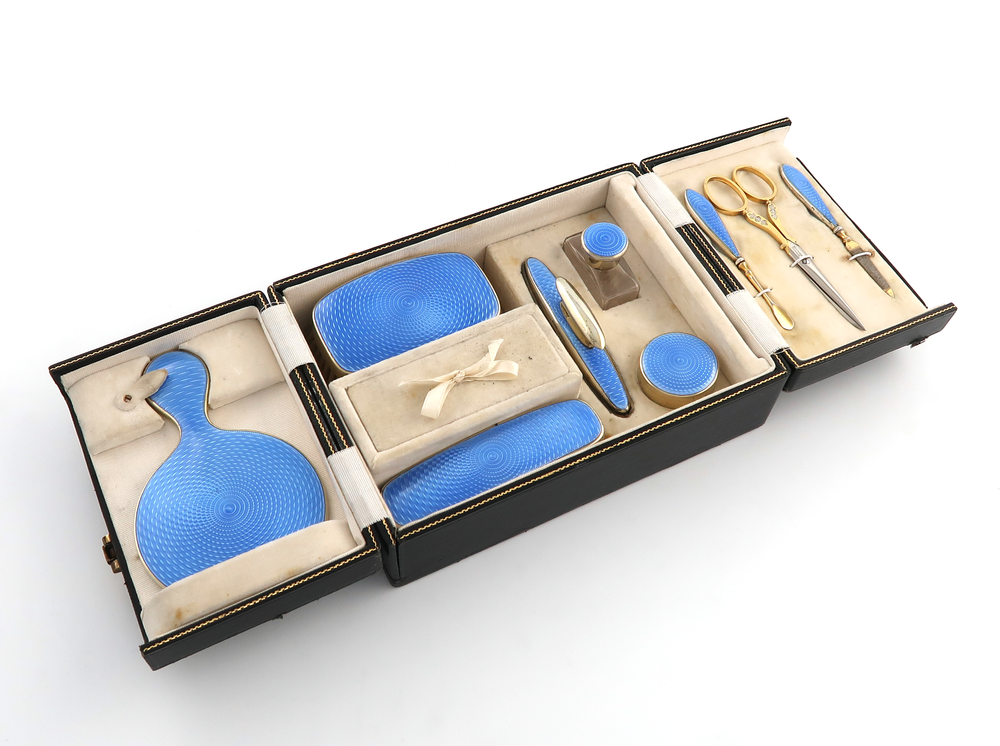 A silver-gilt and blue enamel travelling dressing table set, by J W Benson Ltd, London 1927, plain