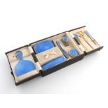 A silver-gilt and blue enamel travelling dressing table set, by J W Benson Ltd, London 1927, plain