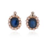 A pair of Russian sapphire and diamond cluster earrings, the oval-shaped sapphires set within a