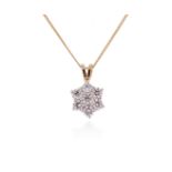 A diamond cluster pendant, set with round brilliant-cut diamonds in two-colour gold, on a fine-