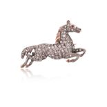 A late 19th century diamond-set horse brooch, the leaping horse pavé-set with old cushion-shaped