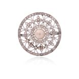 An Edwardian pearl and diamond-set circular brooch, centred with a pearl within an openwork surround