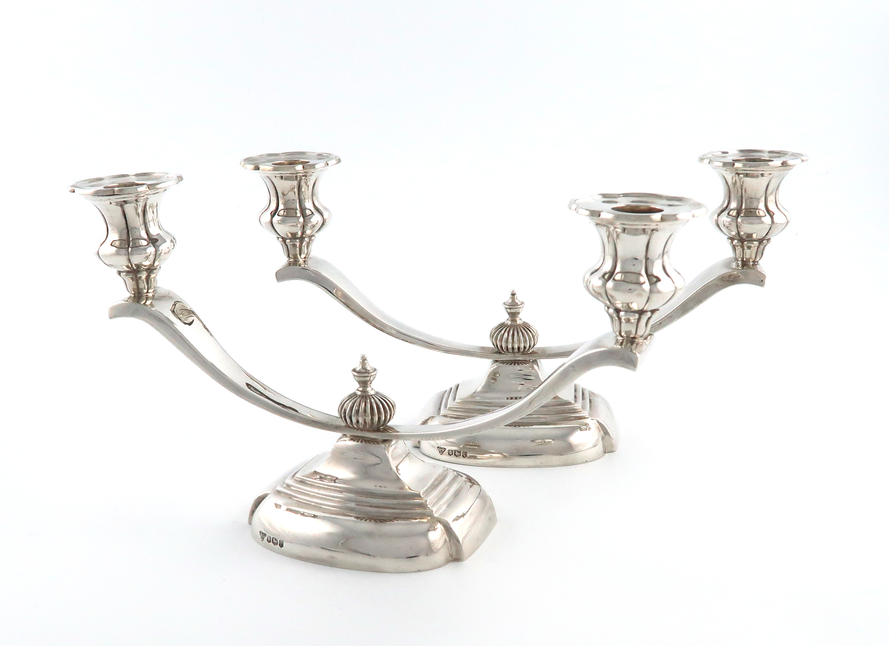 A pair of silver two-light candelabra, by Garrard and Co., Sheffield 1958, on raised shaped