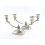 A pair of silver two-light candelabra, by Garrard and Co., Sheffield 1958, on raised shaped