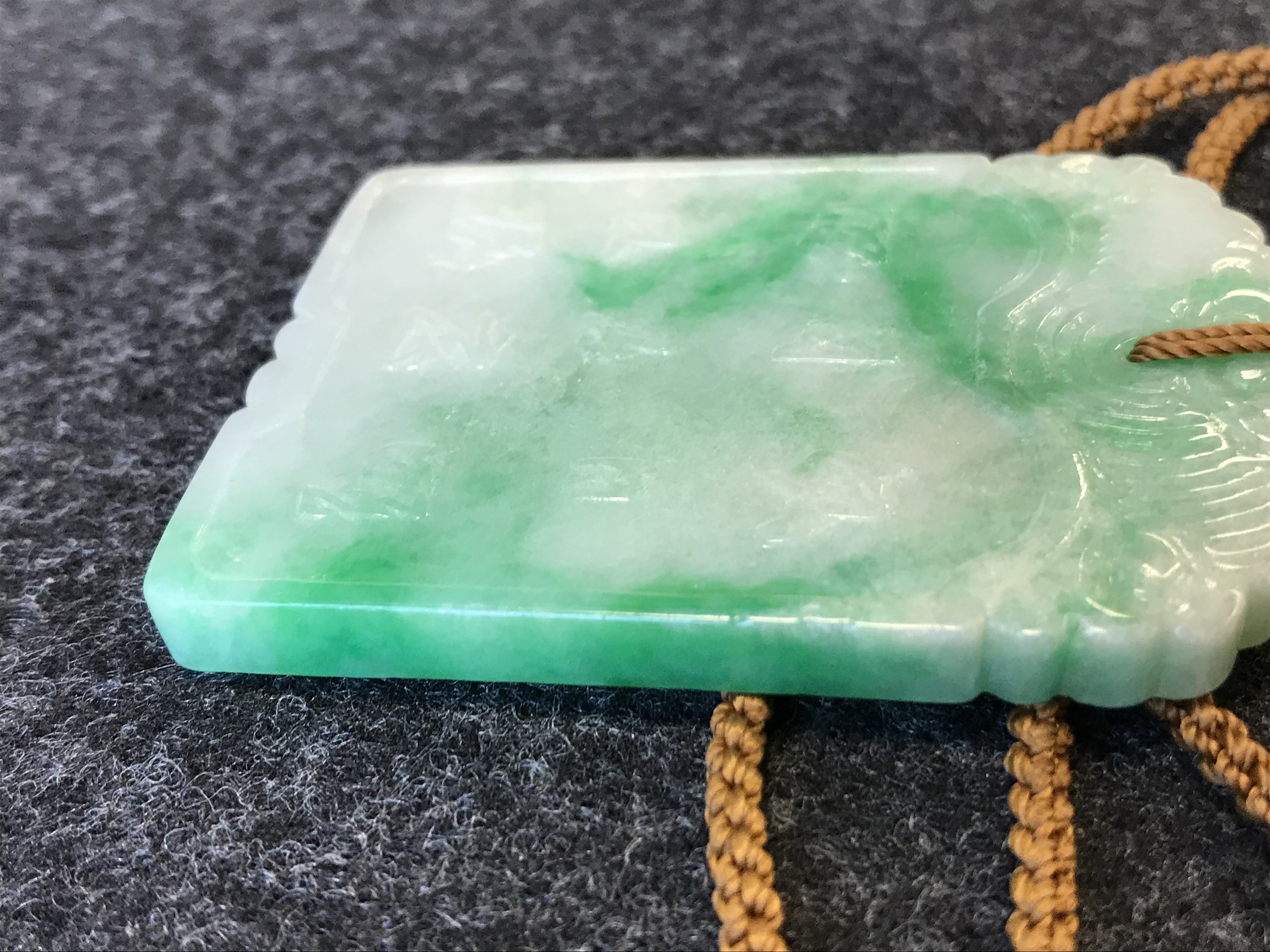 A CHINESE APPLE GREEN JADEITE RECTANGULAR PENDANT QING DYNASTY OR LATER Carved in low relief to - Image 16 of 26