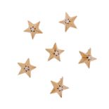 A set of six diamond-set gold star brooches, the three dimensional stars each set with an old