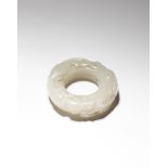 A CHINESE PALE CELADON JADE 'CHILONG' HUAN QING DYNASTY OR LATER Formed as a disc, carved in