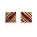 A pair of ruby-set gold cufflinks by Paul Flato, set with a row of calibré-cut rubies in fluted gold