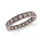 An early 20th century diamond full circle eternity ring, set with old circular-cut diamonds in