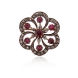 A late 19th century ruby and diamond brooch, the graduated circular-cut rubies set within hexafoil