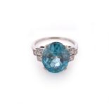 A zircon and diamond ring, the oval-shaped blue zircon is set with three old circular-cut diamonds