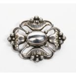 A Georg Jensen silver brooch designed by Georg Jensen, model no.173, pierced and cast with radiating