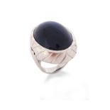 An amethyst cabochon ring by Geoffrey Rowlandson, set in striated rubover white gold mount, maker'