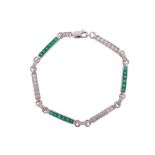 An emerald and diamond flexible bracelet, the links alternately-set with French-cut emeralds and