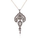 A diamond scroll pendant, set overall with graduated circular-cut diamonds in silver on gold, on