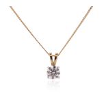 A diamond solitaire pendant, the round brilliant-cut diamond weighs approximately 0.65cts, claw