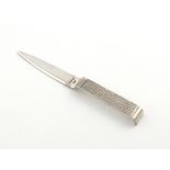 By Gerald Benney, a modern silver letter opener, London 1973, tapering blade, the handle textured