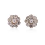 A pair of cultured pearl and diamond earrings, the cultured pearls set within a surround of round