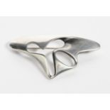 A Georg Jensen silver brooch designed by Henning Koppel, model no.325, pierced and cast abstract