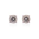 A pair of diamond stud earrings by Cartier, the round brilliant-cut diamonds weigh 0.50cts in total,