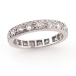 An early 20th century diamond full circle eternity ring, set with old circular-cut diamonds in white