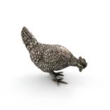 A Dutch novelty silver pepper pot, circa 1920, modelled as a pecking hen, textured feathers, the
