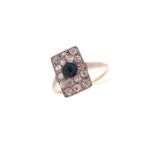 An Edwardian rectangular plaque ring, pave-set with graduated old cushion-shaped diamonds and a